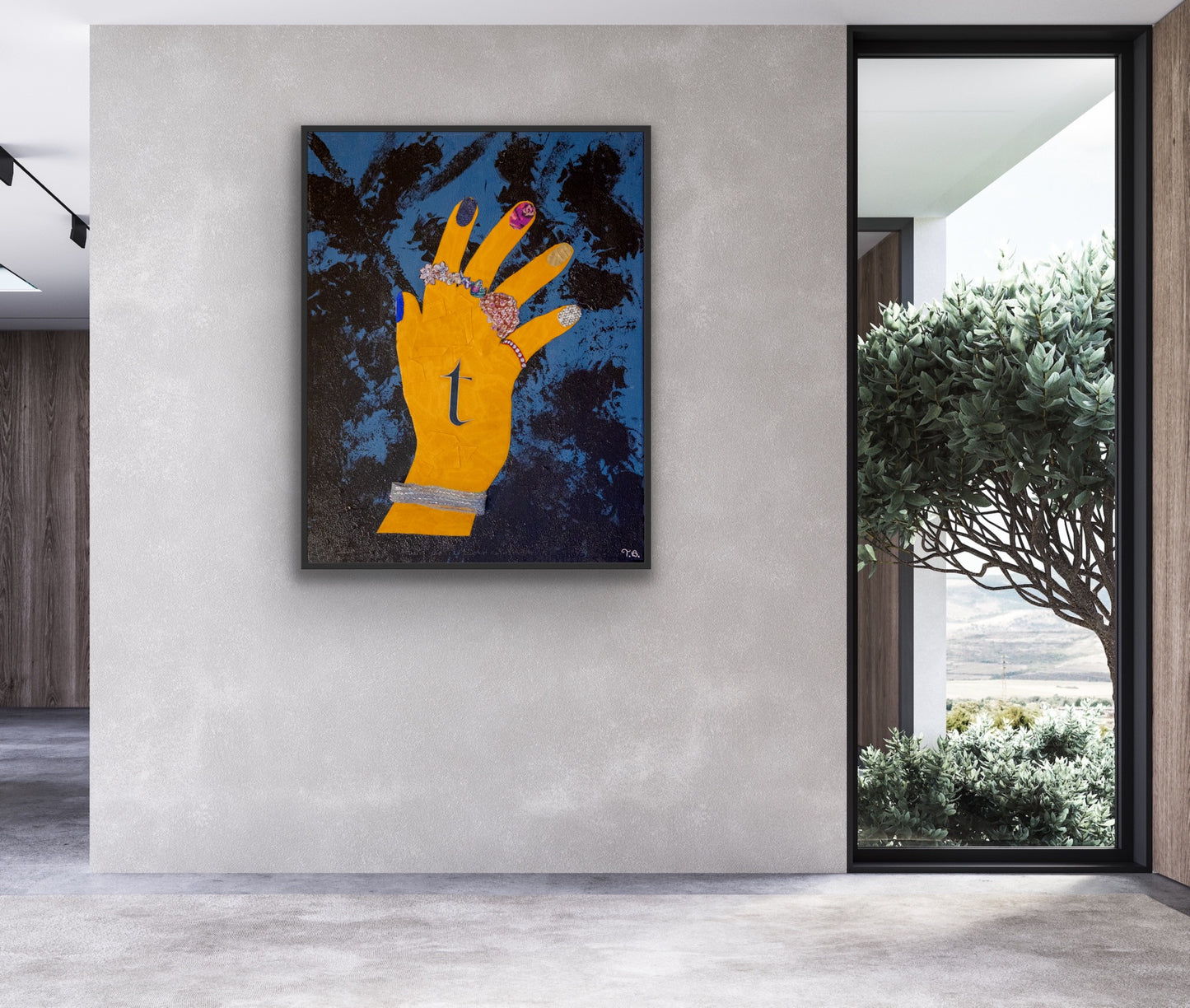 Modern interior with a large abstract painting of a yellow hand on a gray wall.