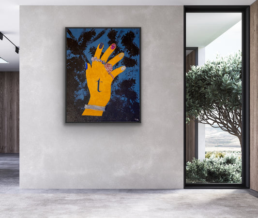 Modern interior with a large abstract painting of a yellow hand on a gray wall.